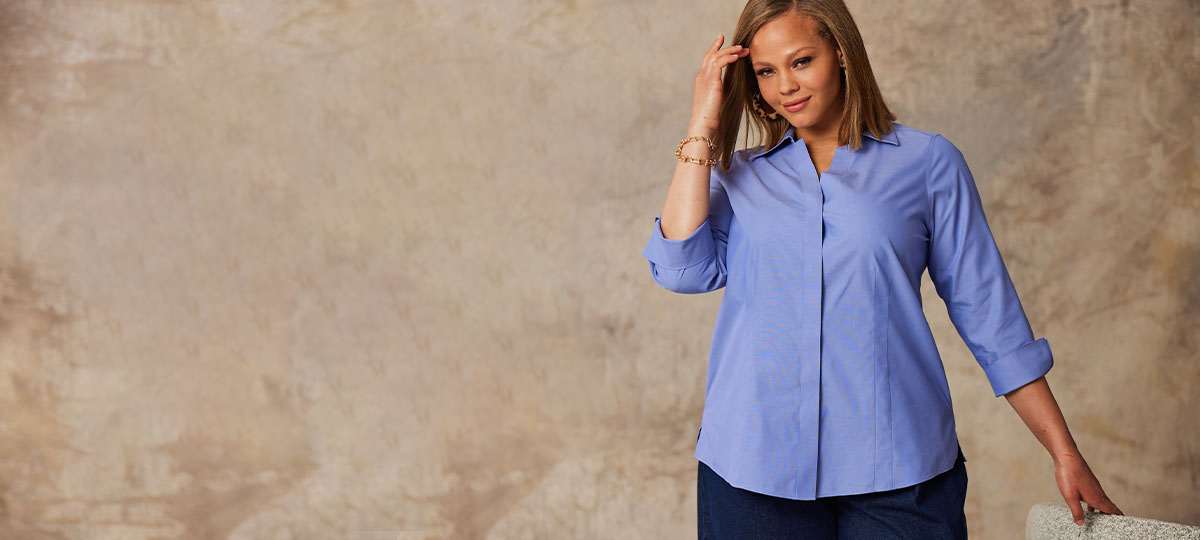 brunette woman wearing a Foxcroft blue wrinkle-free non-iron blouse