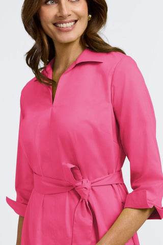 Close up view of the top half of the Agnes Stretch Matte Sateen 3/4 Sleeve Dress
showing off its winged collar and self tied belt #color_pink flambe