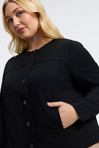 Angled front view of the Valerie Plus Knit Crepe Long Sleeve Jacket showing the full button coverage and the functional pockets #color_black