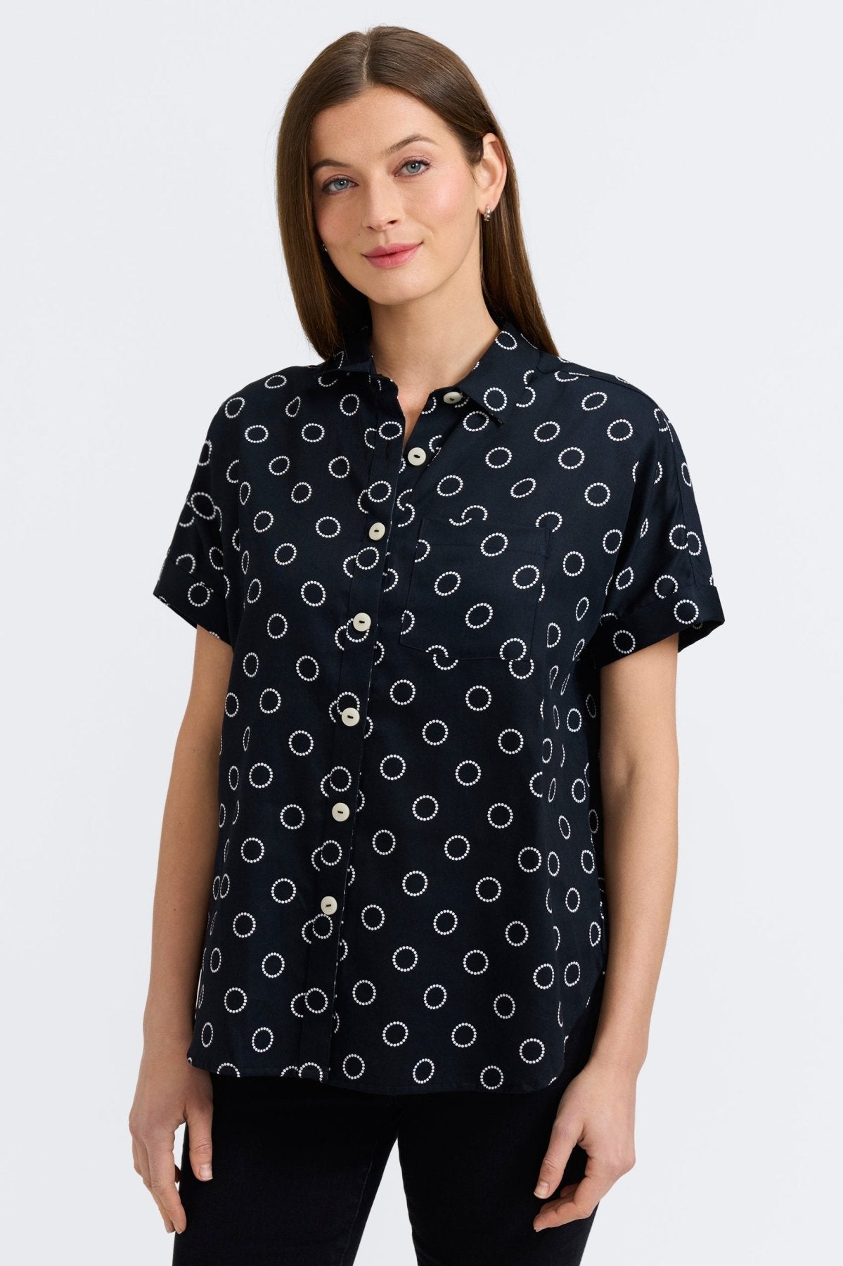 Woman in Foxcroft Abigail short sleeve blouse with playful circle dot print, effortless style