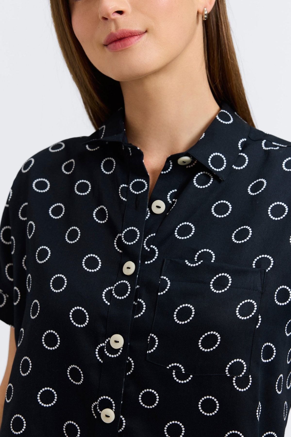 Woman in Foxcroft Abigail short sleeve blouse with playful circle dot print, effortless style