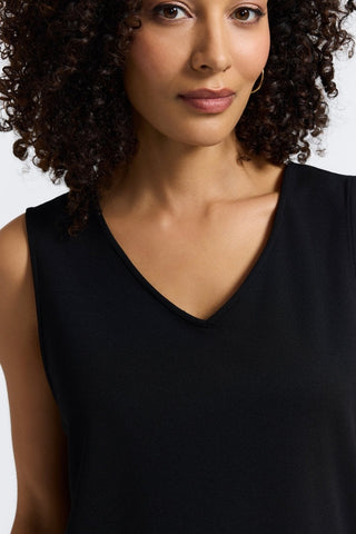 Close-up of the v-neck of the Callie reversible sleeveless tank in #color_black
