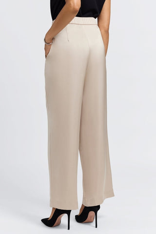 Angled back view of the satin trousers with a dart coming from the waistband #color_champagne