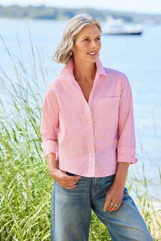 Woman outdoors wearing a Jodie pinpoint stripe long sleeve short shirt in #color_coral reef pinpoint stripe