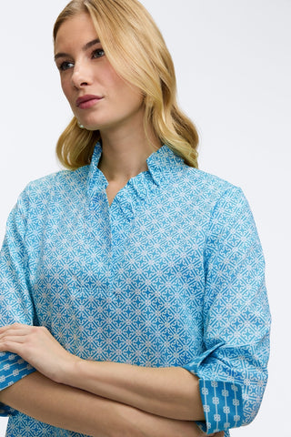 Close up front view of the Tammy Petite Geo Lattice 3/4 Sleeve Popover Shirt
featuring the subtle ruffle collar and v-neckline #color_blue/white geo lattice