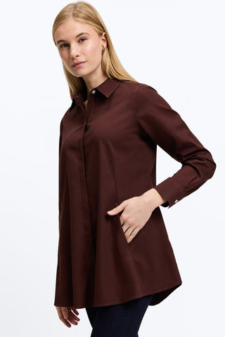 Angled front view of a woman wearing the Cici No Iron Pinpoint Long Sleeve Tunic with her hand in pocket #color_chicory coffee
