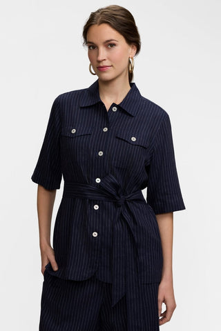 Front view of the buttoned Estela Pinstripe Linen Short Sleeve Jacket with the wait tie cinched for a fitted look 