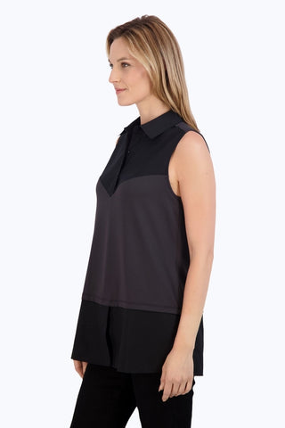 Angled side view of women wearing Sasha Knit-Woven Sleeveless Layering Tunic #color_black