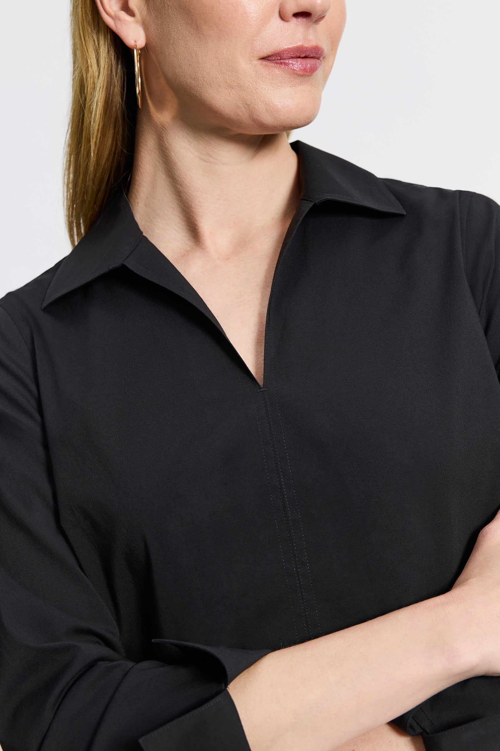 #color_black Woman in Foxcroft Agnes black wrinkle-free shirt designed for modern polish and everyday ease.