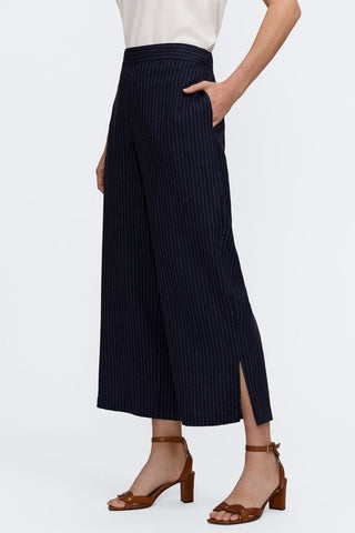 Full angle side view of pinstriped linen cropped pants and then subtle side slit  