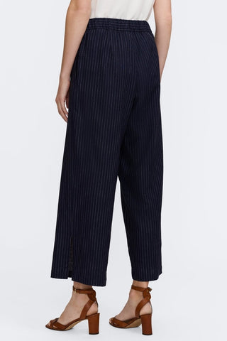 Angled back view of the pinstriped cropped wide leg pants 