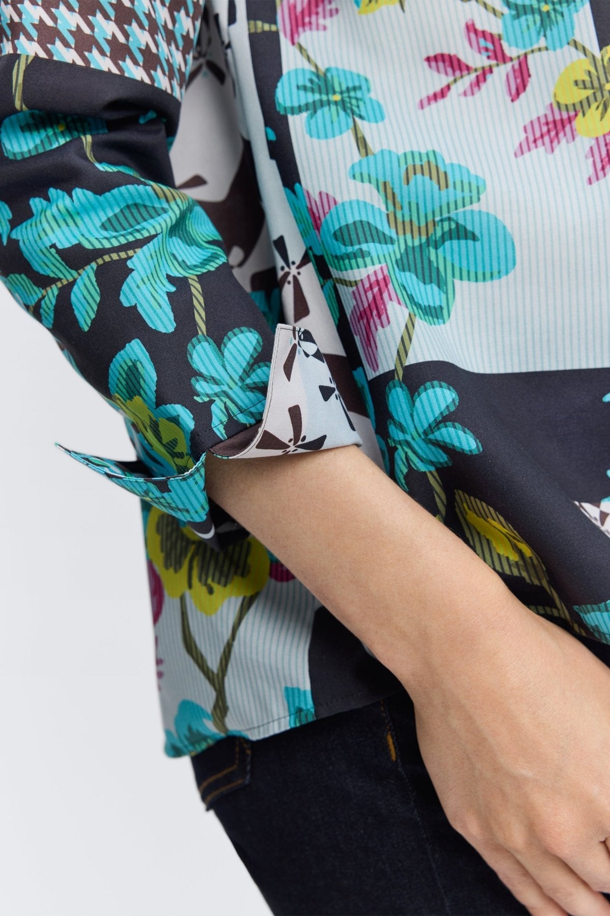 Woman wearing Foxcroft teal multi-print blouse with flattering fit