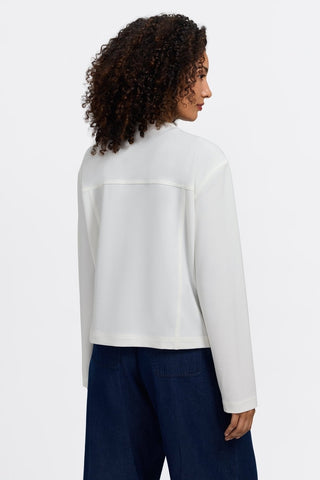 Woman in Foxcroft Valerie long-sleeve jacket in ecru with chic layering style