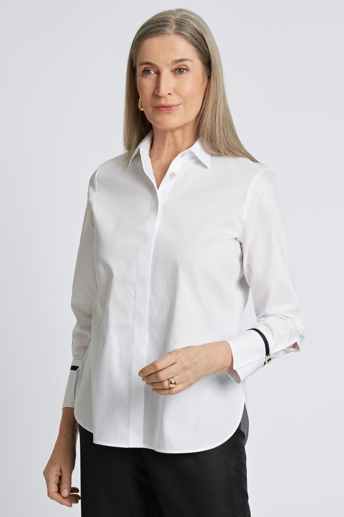 Woman wearing Foxcroft Iris shirt in crisp white, a timeless button-down essential.