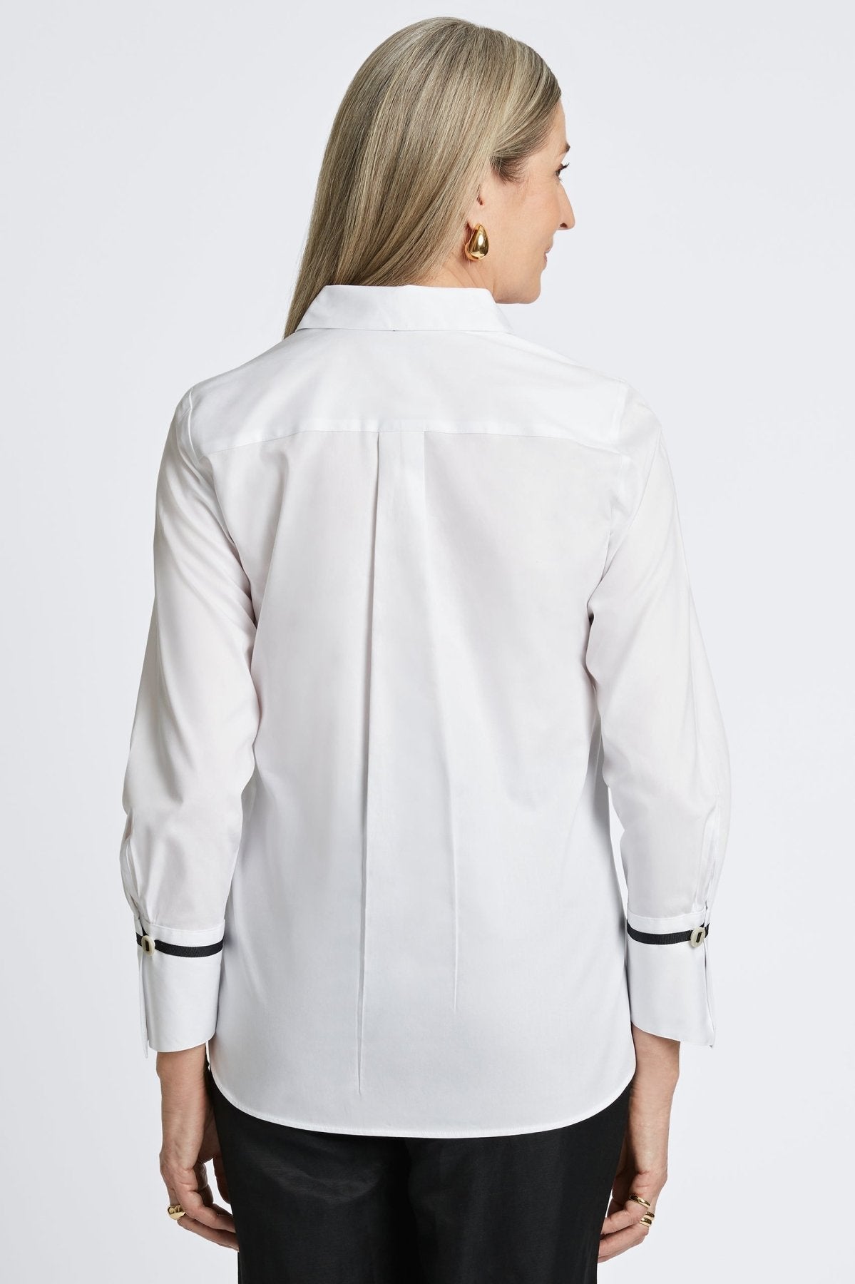 Woman wearing Foxcroft Iris shirt in crisp white, a timeless button-down essential.