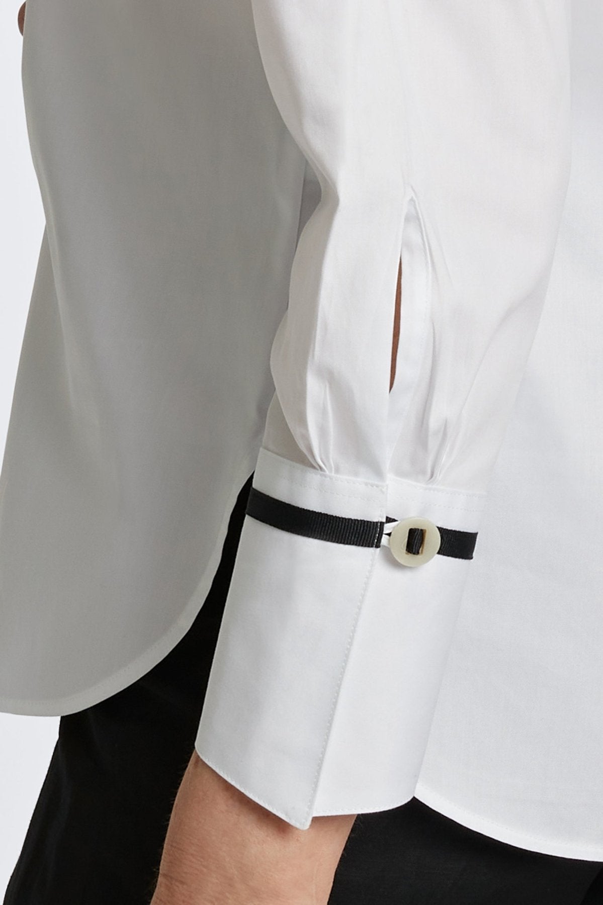 Woman wearing Foxcroft Iris shirt in crisp white, a timeless button-down essential.