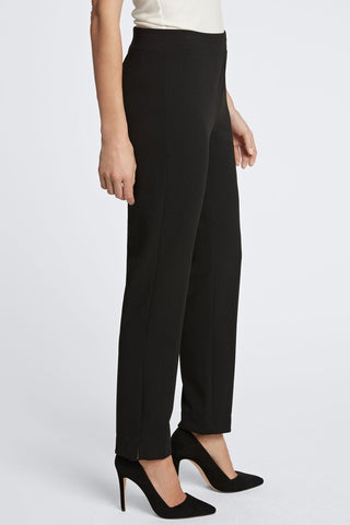 Angled side view of the sleek ankle length pants #color_black
