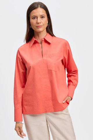 Front view of woman wearing the Bella No Iron Stretch Long Sleeve Shirt
with the full length sleeves #color_tangerine