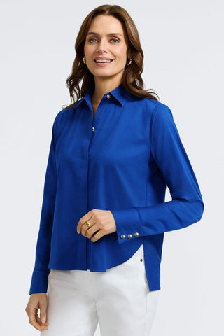 Angled front view of women wearing Pearl Stretch Matte Sateen Long Sleeve Shirt
with bent arm #color_blue topaz