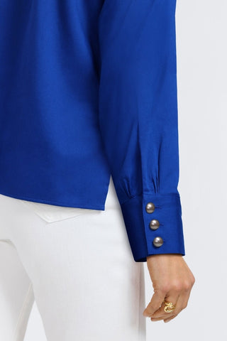 Back angled view of three oversized pearl buttoned cuff on the sleeze of the Pearl Stretch Matte Sateen Long Sleeve Shirt
#color_blue topaz
