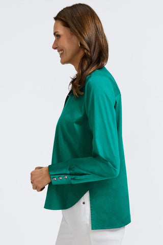 Side view of women with bent arm showing off the three oversized pearls on the cuffs of the Pearl Stretch Matte Sateen Long Sleeve Shirt #color_emerald