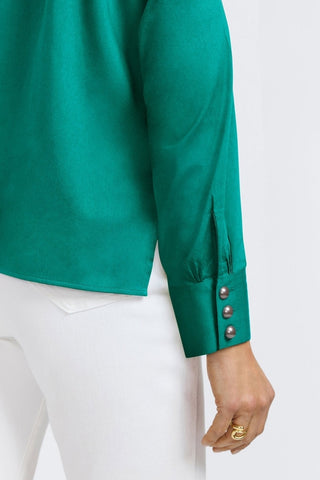 Back angled view of the sleeve and oversized pearled cuff of the Pearl Stretch Matte Sateen Long Sleeve Shirt #color_emerald