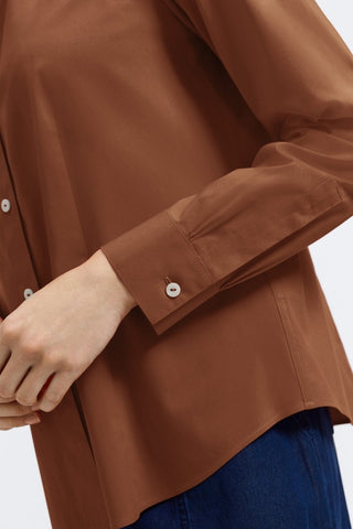 Angled view of a womens bent arm wearing the June No Iron Stretch Long Sleeve Shirt showing off the sleeve and buttoned cuff #color_macchiato