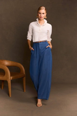 Woman wearing the Tammy Knit Crepe 3/4 Sleeve Popover Shirt tucked into her jeans and her sleeves pushed up a little #color_ecru