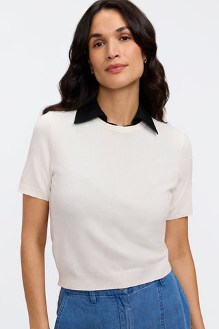 Model wearing the Taylor Knit-Woven Sleeveless Layering Tank underneath a white shirt #color_black