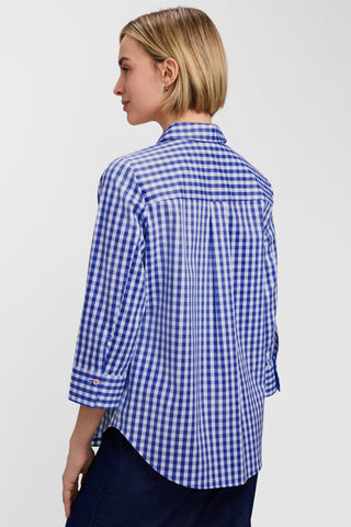 Angled back view of a model wearing the Margie Gingham Stretch Matte Sateen 3/4 Sleeve Shirt untucked with a pair of jeans #color_deep sea/white gingham