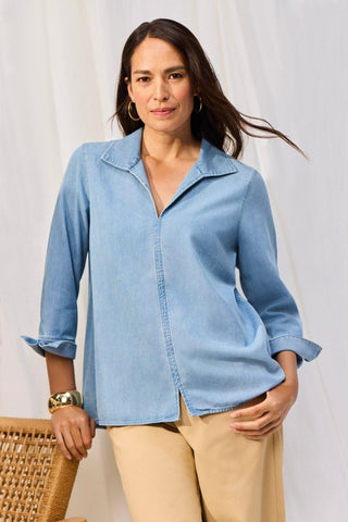 Woman in a bleach-wash Tencel button-down shirt from Foxcroft, styled for comfort and everyday polish.