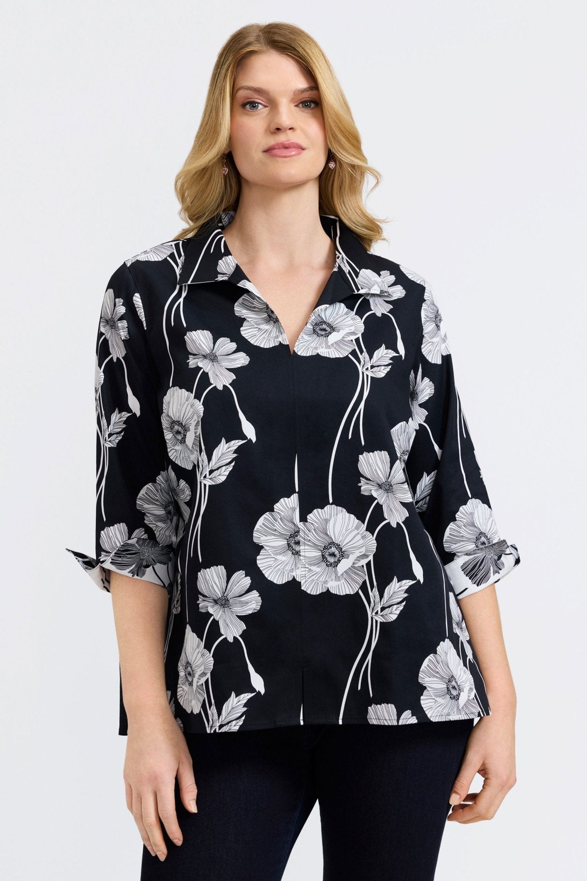 Woman in Foxcroft Agnes shirt with dark black poppy floral print, chic and feminine design