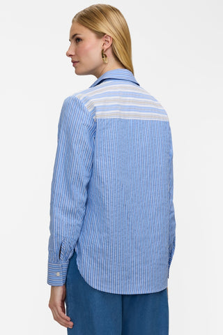 Angled back view of model wearing the Meghan Pucker Colorblock Long Sleeve Shirt