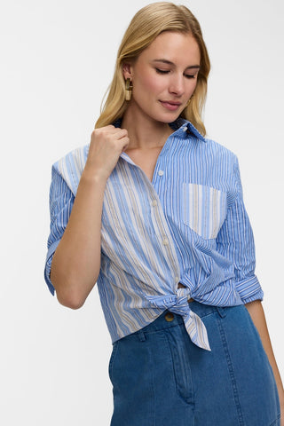 Front view of model wearing theMeghan Pucker Colorblock Long Sleeve Shirt tied in a knot in the front to crop it with sleeves rolled to elbows 
