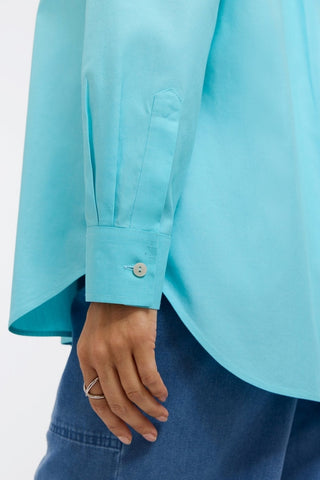 Close up of sleeve and buttoned cuff of the Boyfriend Pinpoint Non-Iron Tunic #color_capri