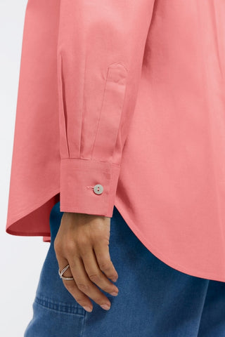 Angled close up view of the cuff and sleeve the Boyfriend Pinpoint Non-Iron Tunic #color_coral reef 