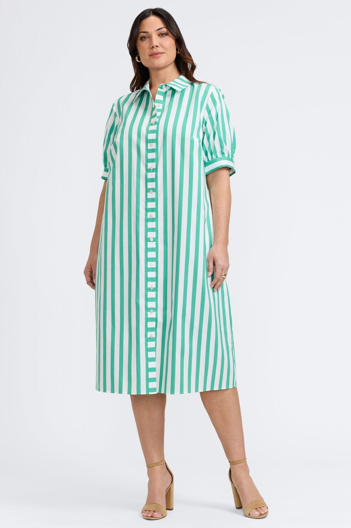 Plus-size woman in a green and white striped seersucker dress from Foxcroft, lightweight and easy for warm-weather days.