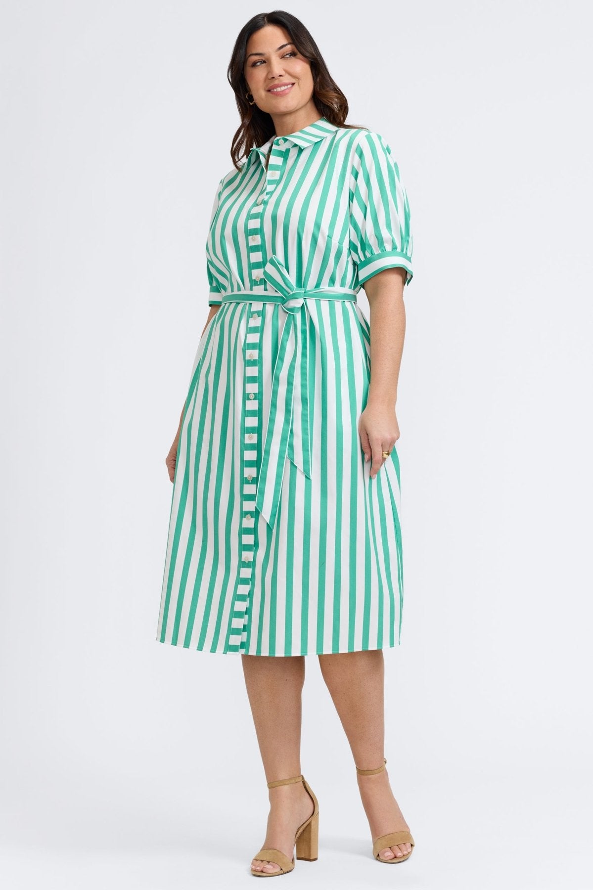 Plus-size woman in a green and white striped seersucker dress from Foxcroft, lightweight and easy for warm-weather days.