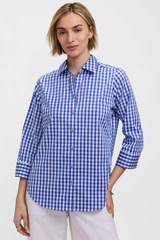 Front view of model wearing the Margie Gingham Stretch Matte Sateen 3/4 Sleeve Shirt untucked with a pair of white pants #color_deep sea/white gingham