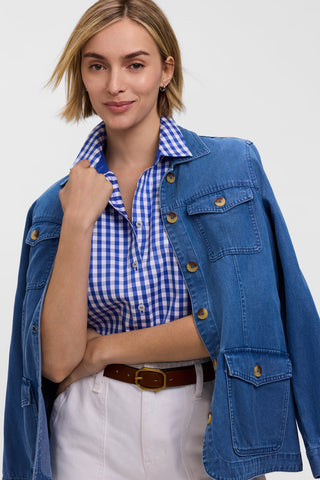 Model wearing the Margie Gingham Stretch Matte Sateen 3/4 Sleeve Shirt
tucked into her pants with a denim jacket draped over her shoulders #color_deep sea/white gingham