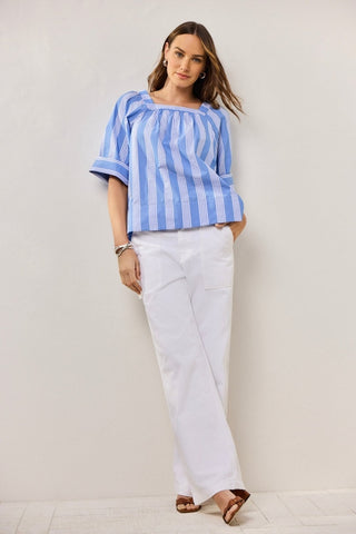 Plus-size model in a textured seersucker Blue shirt with soft white stripes, styled for breathable ease and polished charm.