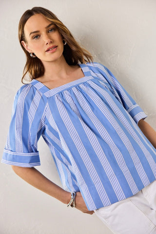 Plus-size model in a textured seersucker Blue shirt with soft white stripes, styled for breathable ease and polished charm.