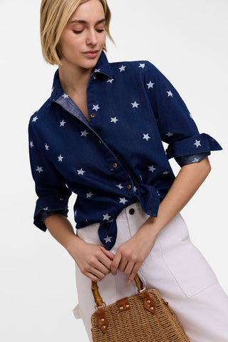 Model wearing the Meghan Tencel Star Embroidery Long Sleeve Shirt with bottom tied up paired with white pants and wicker purse 
