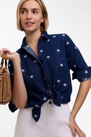Model wearing the Meghan Tencel Star Embroidery Long Sleeve Shirt with the bottom tied up and white pants posing with a purse