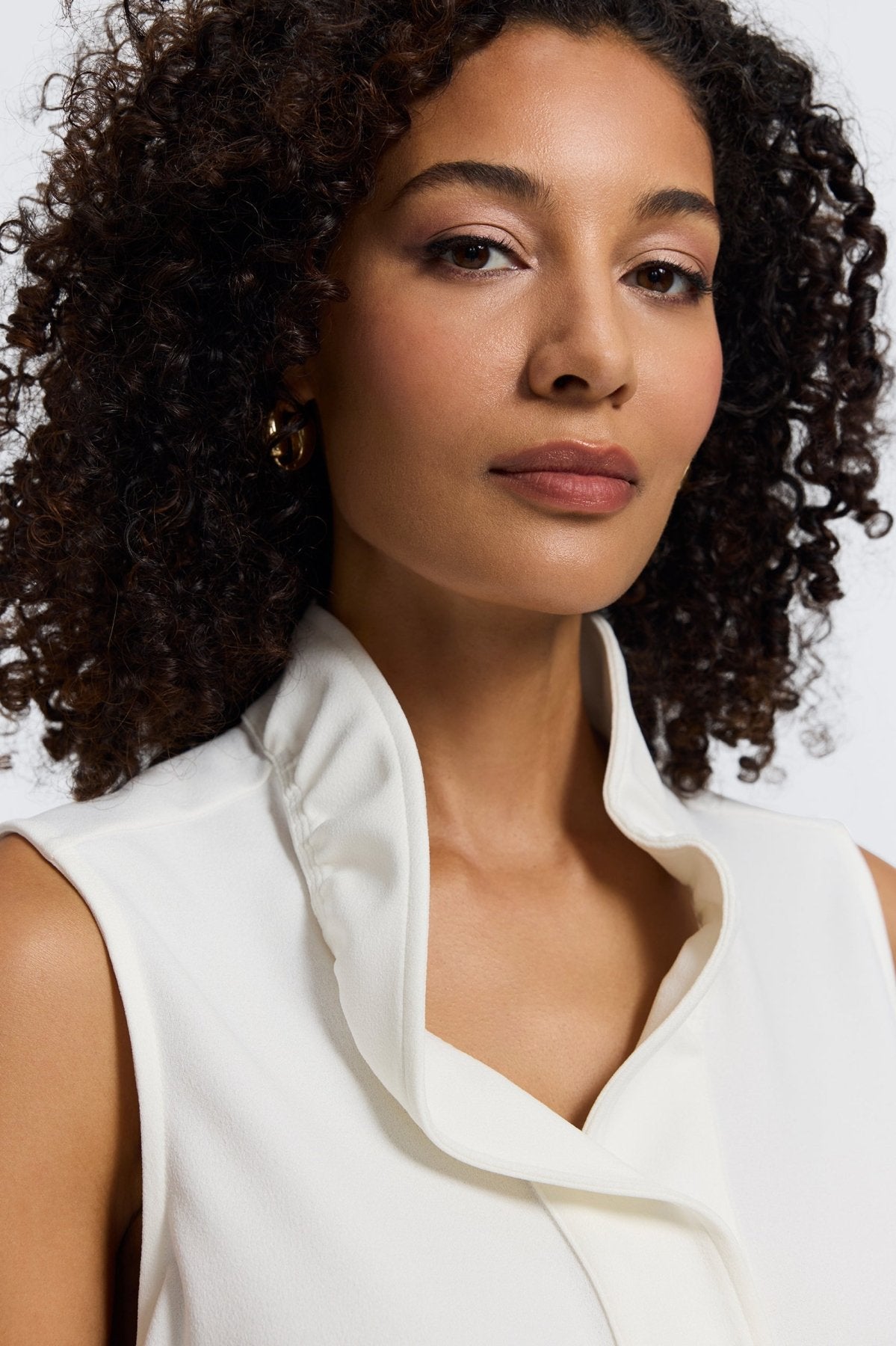 Woman in Foxcroft Tammy sleeveless knit crepe top in ecru