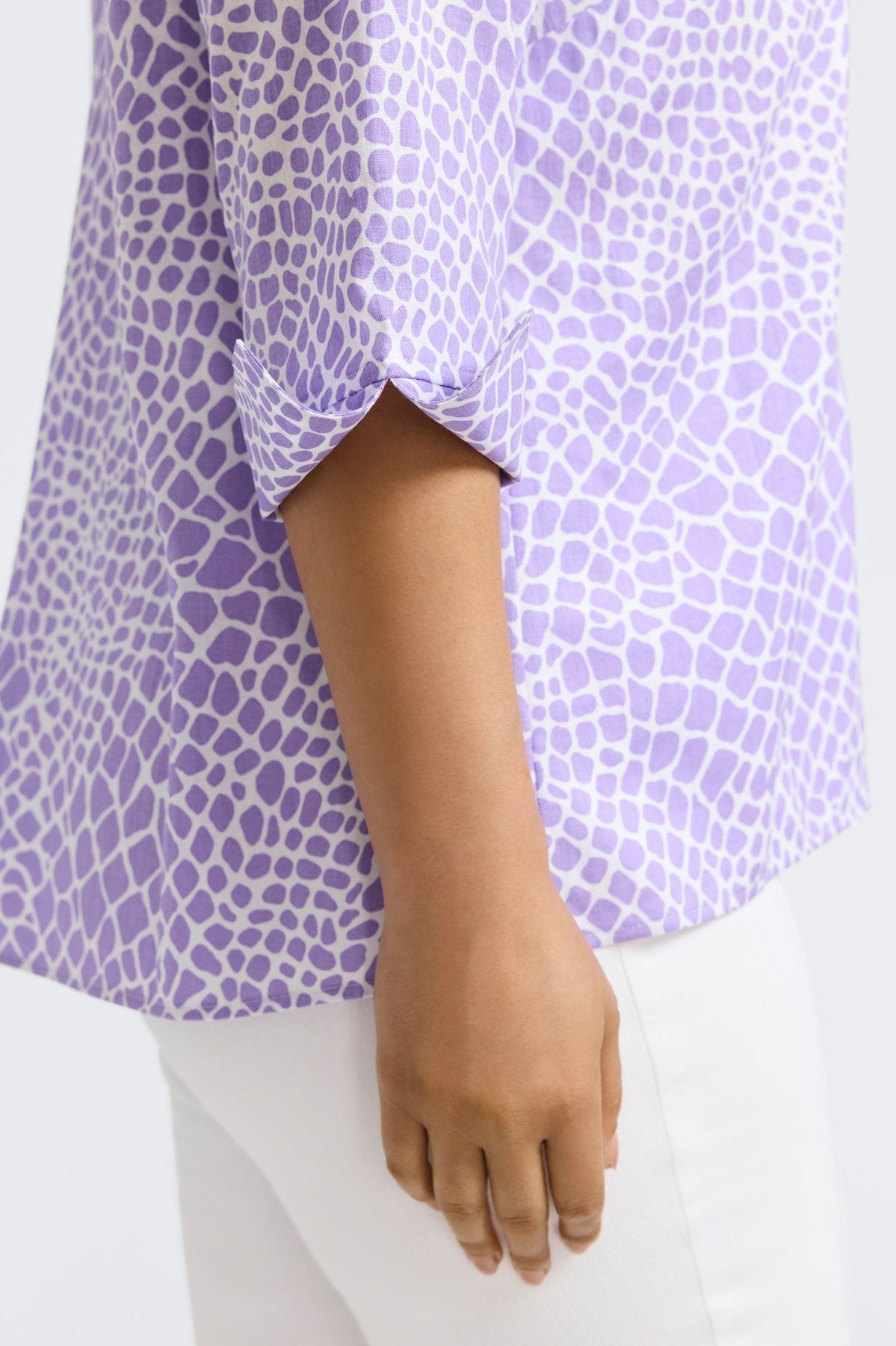 Woman wearing Foxcroft Agnes linen blouse in giraffe amethyst print