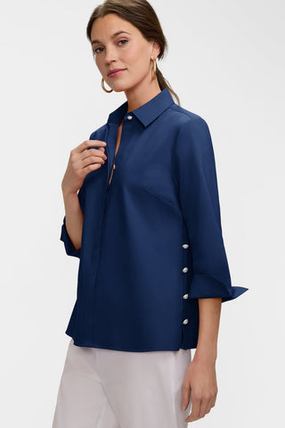 Angled front view of the Beatrice Pearl Stretch Matte Sateen 3/4 Sleeve Shirt
with the turnback cuffs and the pearl buttoned side slit #color_navy