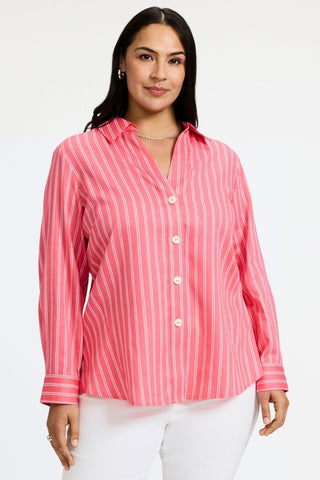 Plus-size woman in a sunkist coral blouse from Foxcroft, designed for lightweight comfort and timeless appeal.