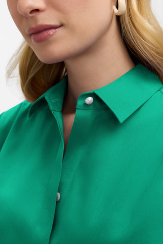 Close up of the single pearl button underneath the collar of the Beatrice Pearl Stretch Matte Sateen 3/4 Sleeve Shirt #color_kelly green