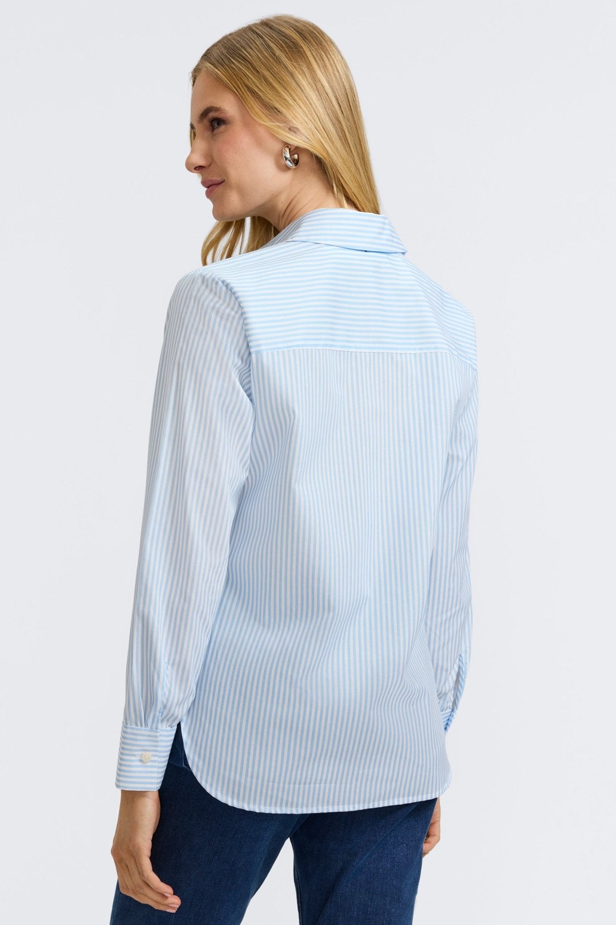 Plus-size woman in a blue floral stripe button-down from Foxcroft, offering cheerful sophistication with breathable ease. (4)